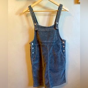 Sleeveless overall mini dress with a front and back pockets.